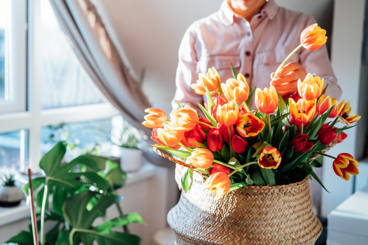 Woman setting up flower bouquet. Photography by Okrasiuk via Shutterstock