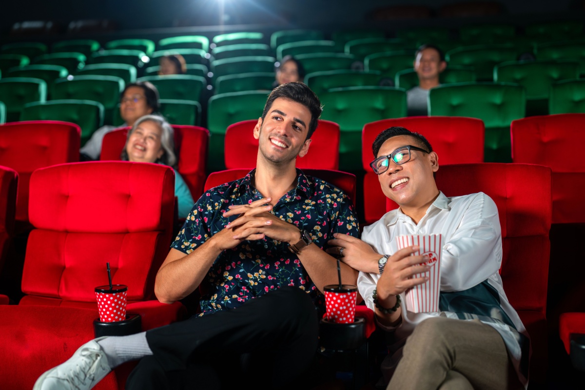 Two guys watching movie in cinema. Photography by anek.soowannaphoom. Image via Shutterstock