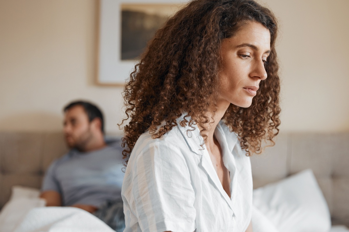 Woman and man upset on bed. Photography by PeopleImages.com - Yuri A via Shutterstock