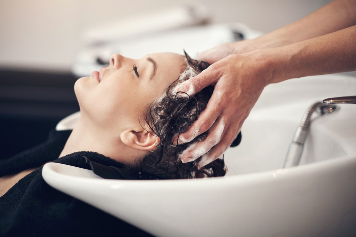 Woman getting hair washed. Photography by PeopleImages.com - Yuri A via Shutterstock