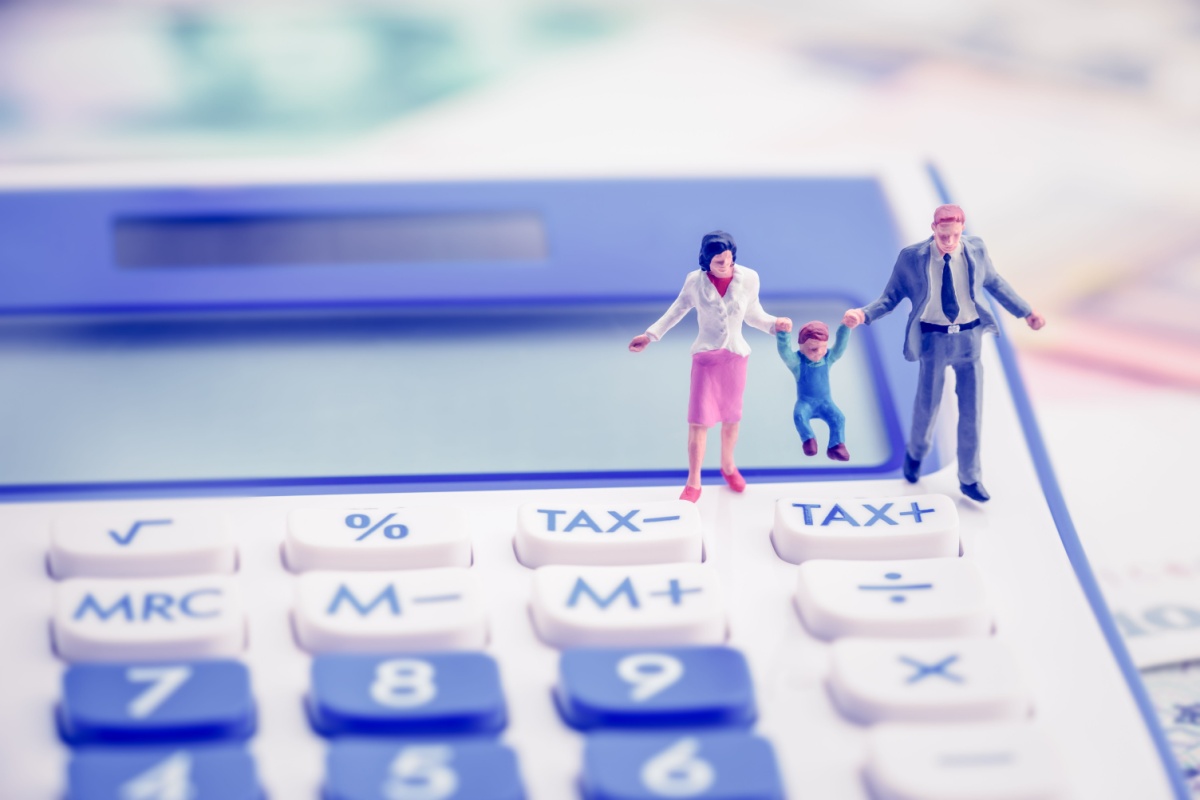 Family figure on top of calculator. Photography by William Potter via Shutterstock